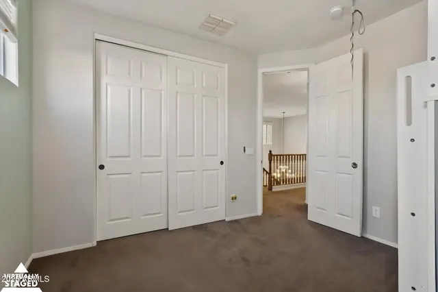 a view of an empty room with closet area