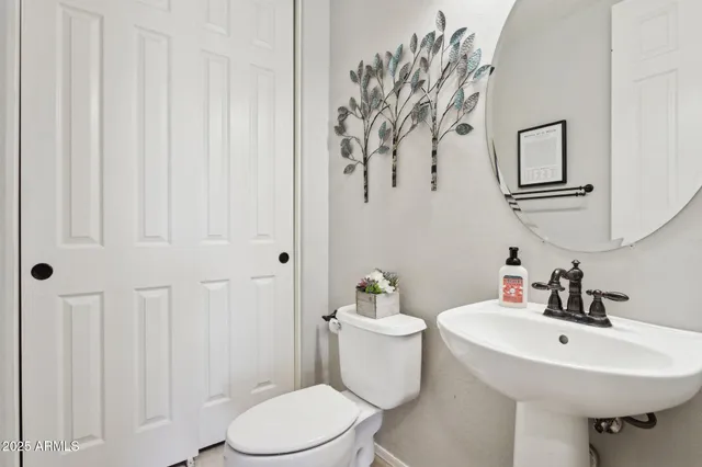 a bathroom with a toilet a sink and a mirror