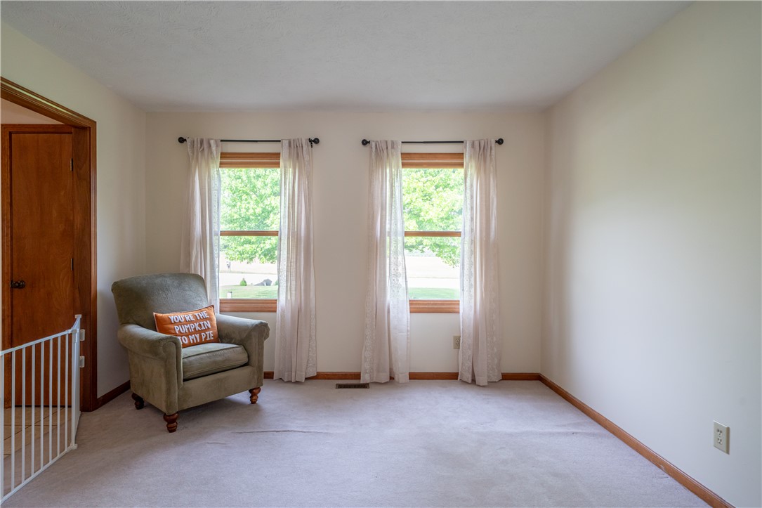 3628 Petre Road Springfield, OH 45502 - Photo 10 of 52 This bright living space features large windows overlooking lush greenery, creating a serene indoor atmosphere.