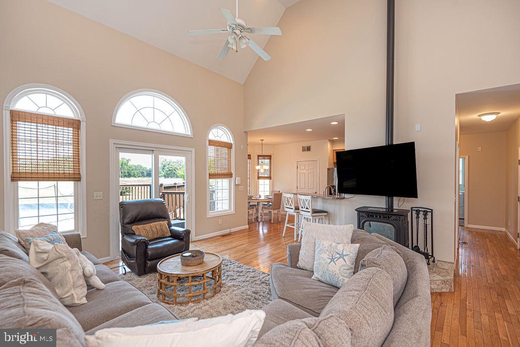 10671 Cathell Road Berlin, MD 21811 - Photo 17 of 63 a living room with furniture a flat screen tv and a large window
