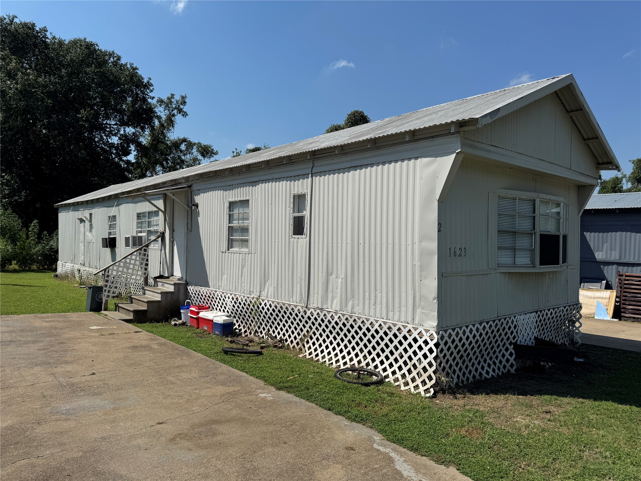 1623 Brazos Street Hempstead, TX 77445 - Photo 12 of 13 a front view of a house with a yard