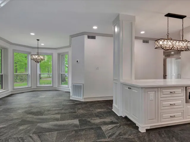 a view of a hallway with chandelier and entryway