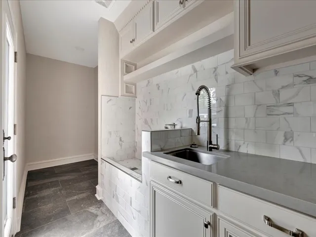 a view of a storage and utility room with cabinet