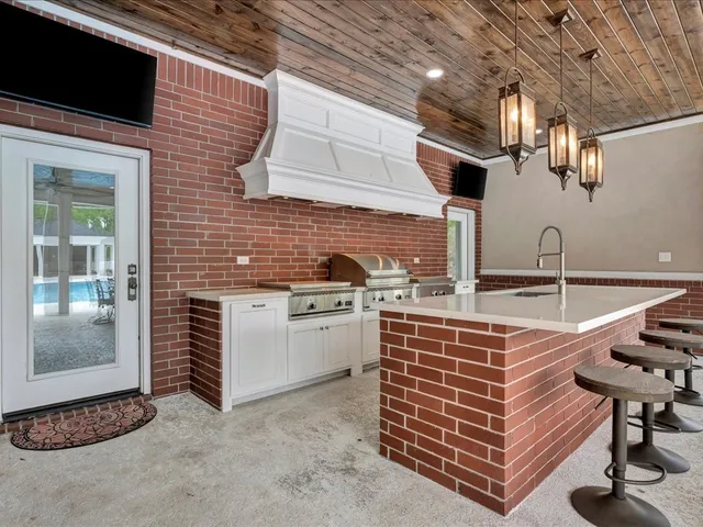 a view of a livingroom with wooden floor and a ceiling fan