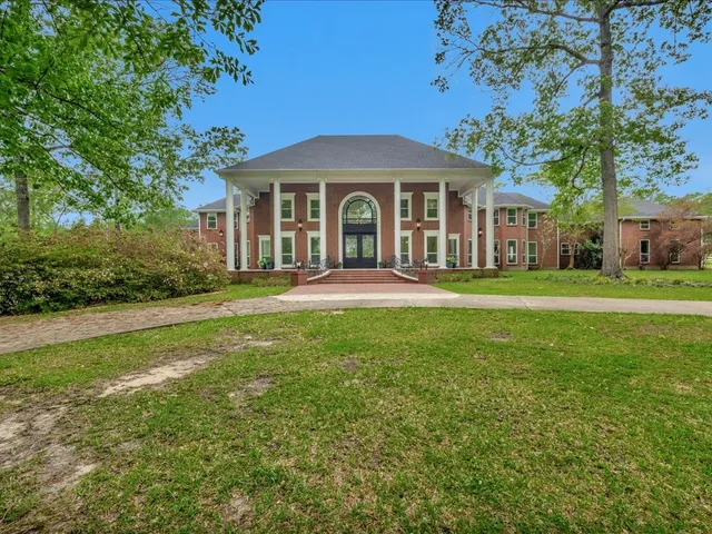 a view of a house with a backyard and garden