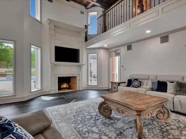 a living room with furniture a flat screen tv and a fireplace