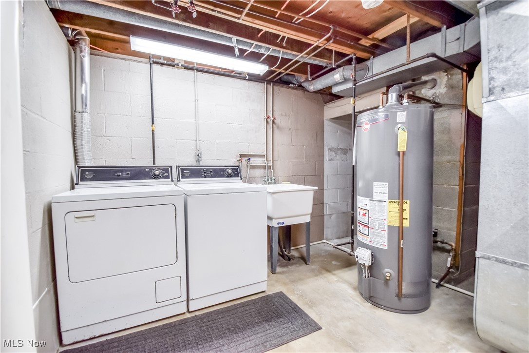 5618 Dolphin Road Mentor, OH 44060 - Photo 35 of 46 Washroom with water heater, separate washer and dryer, unfinished concrete flooring, and heating unit