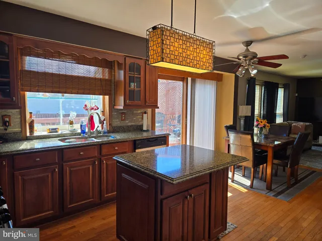 a living room with furniture a fireplace and a large window