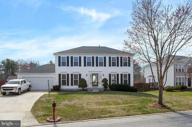a view of a house with a yard and trees