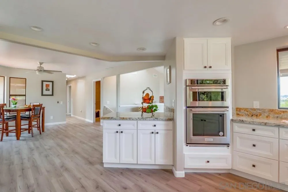 1660 Grove Road El Cajon, CA 92020 - Photo 11 of 44 a kitchen with granite countertop a stove and a refrigerator