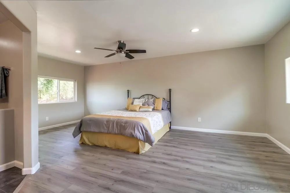 1660 Grove Road El Cajon, CA 92020 - Photo 12 of 44 a bedroom with a bed and wooden floor