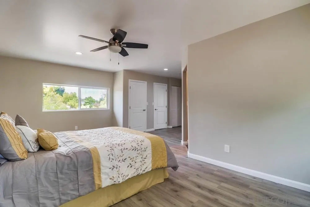 1660 Grove Road El Cajon, CA 92020 - Photo 16 of 44 a bedroom with a large bed chandelier and a window