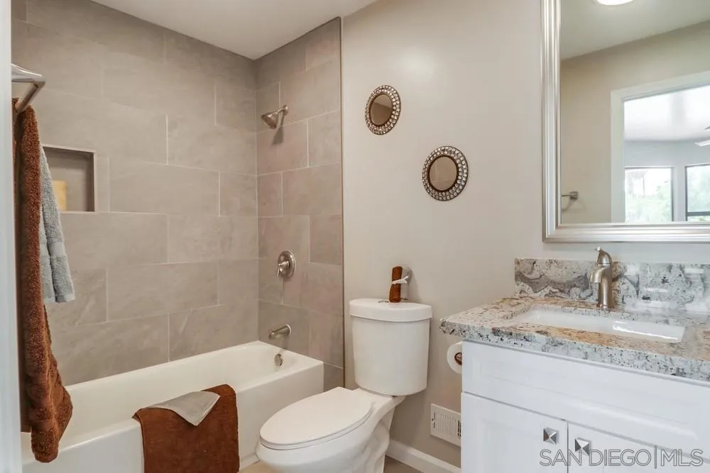 1660 Grove Road El Cajon, CA 92020 - Photo 18 of 44 a bathroom with a granite countertop sink a toilet and shower