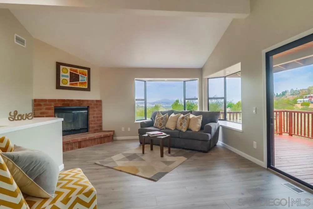 1660 Grove Road El Cajon, CA 92020 - Photo 2 of 44 a living room with furniture a large window and a fireplace