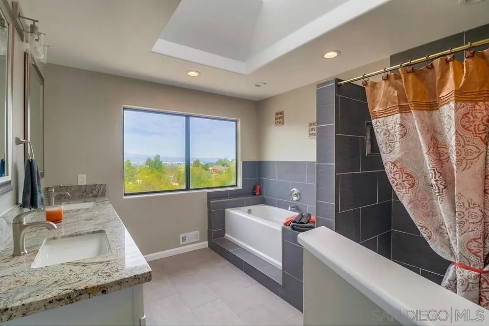 1660 Grove Road El Cajon, CA 92020 - Photo 21 of 44 a bathroom with a granite countertop sink and a large mirror