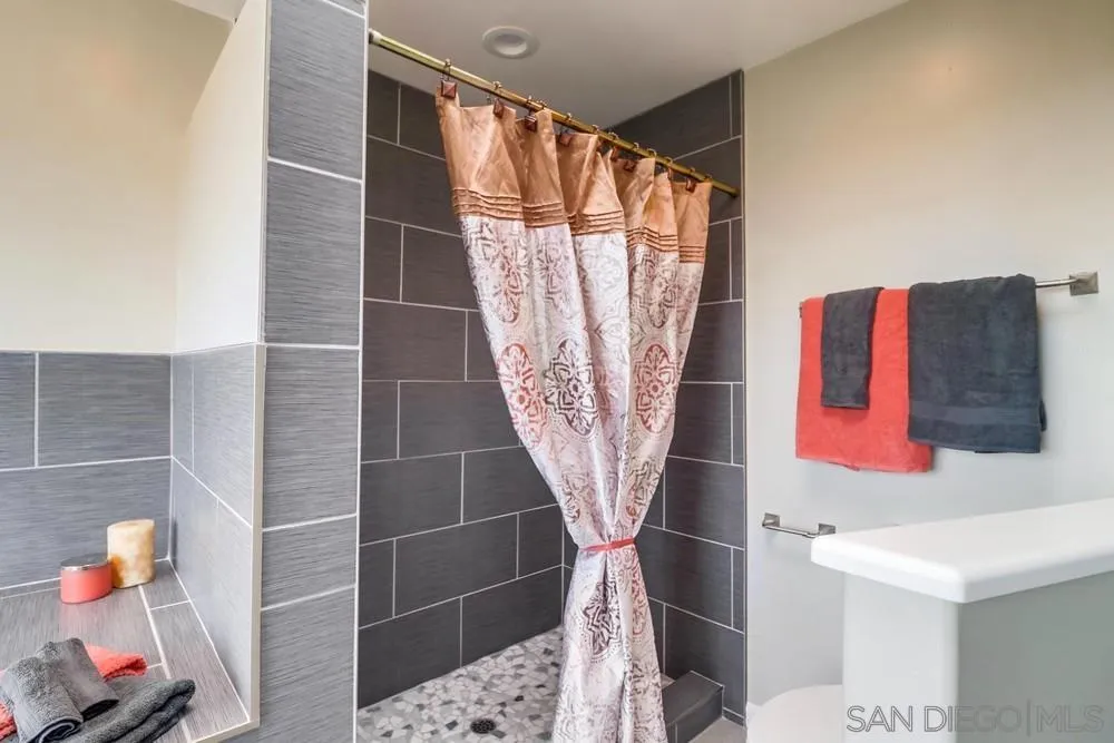 1660 Grove Road El Cajon, CA 92020 - Photo 22 of 44 a bathroom with a sink and a shower curtain