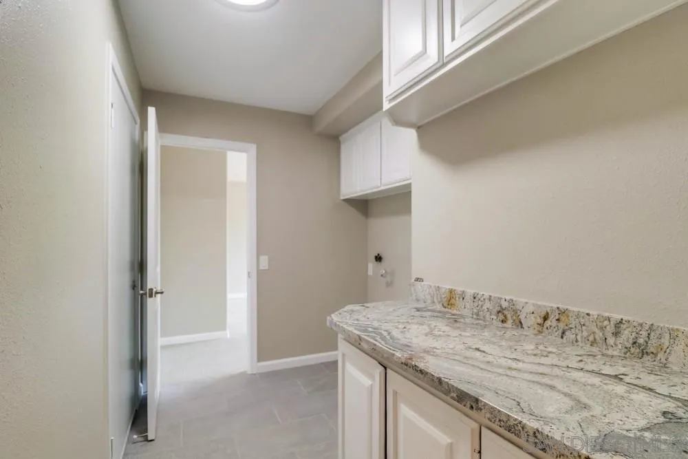 1660 Grove Road El Cajon, CA 92020 - Photo 33 of 44 a bathroom with a granite countertop sink and a mirror