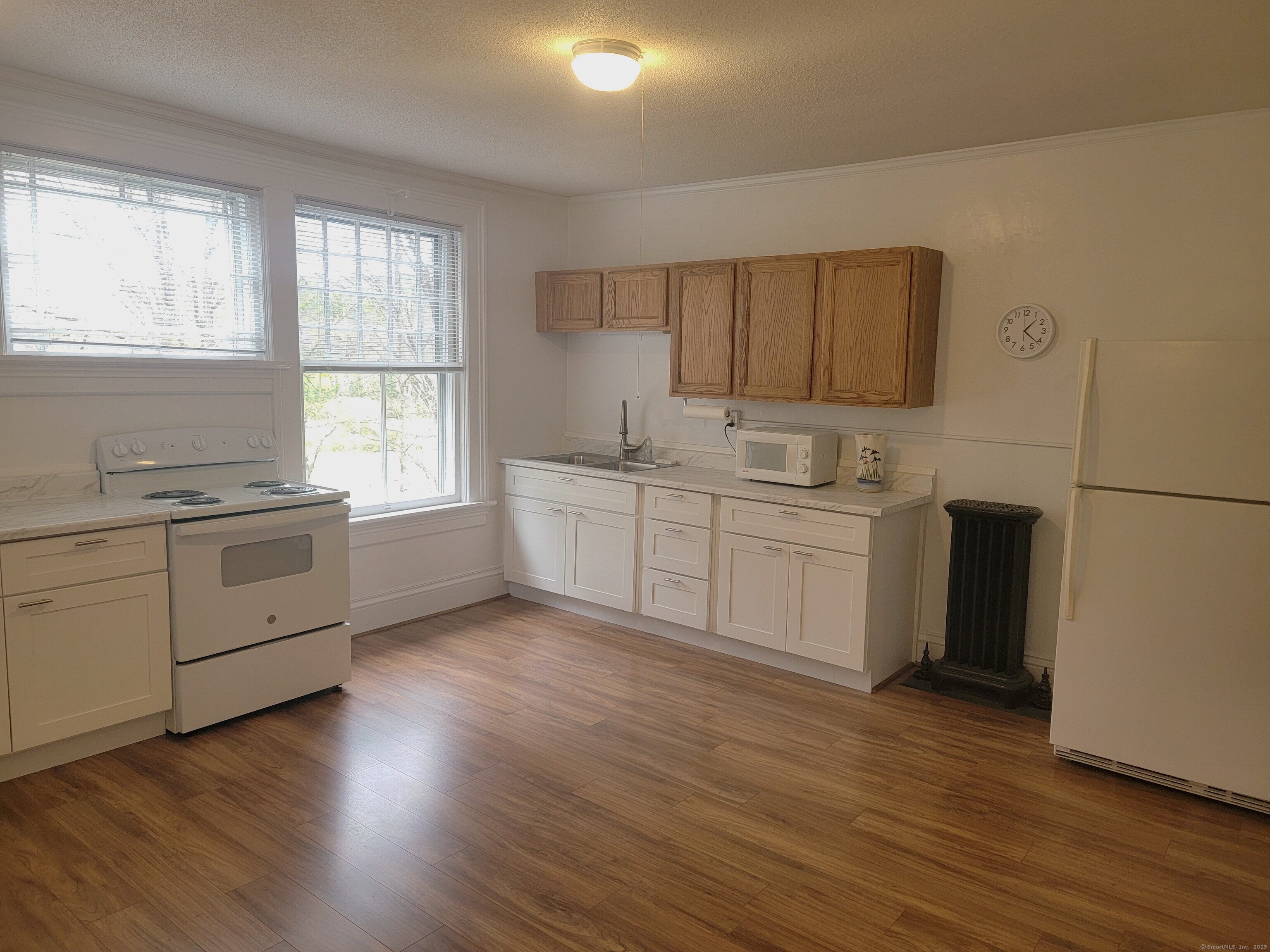 270 Cherry Brook Road, Unit 2 Canton, CT 06019 - Photo 8 of 19 a kitchen with white cabinets and wooden floor