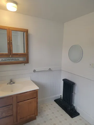 a bathroom with a sink a vanity and mirror