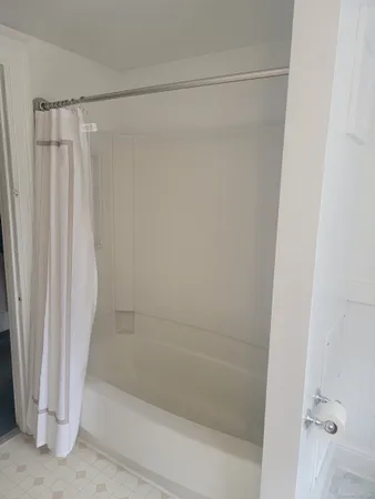 a bathroom with a shower and a bath tub