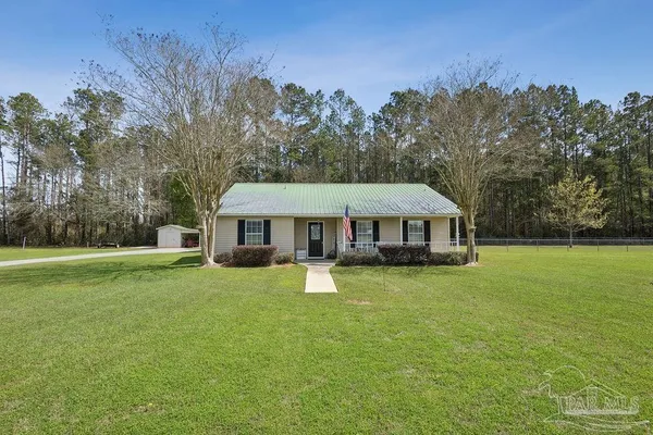 a view of a house with a yard