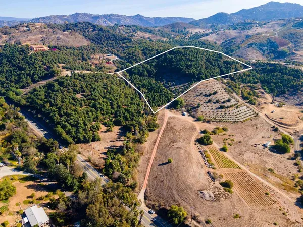 an aerial view of a house with a mountain