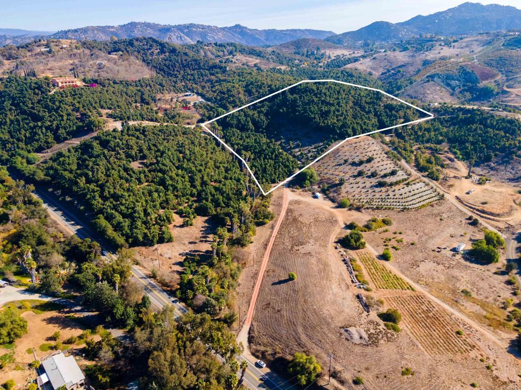 an aerial view of a house with a mountain