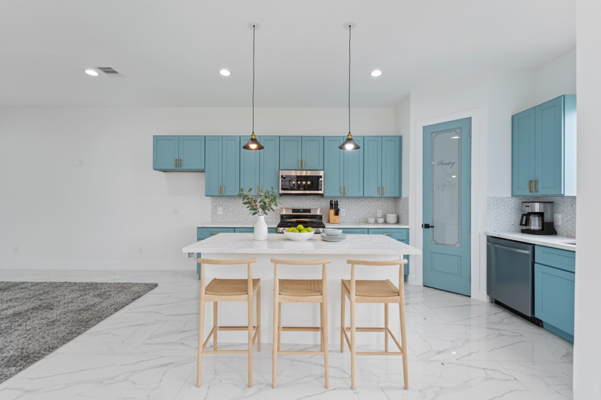7709 Willow Street Houston, TX 77088 - Photo 8 of 15 This view shows the main kitchen wall with a full bank of upper and lower blue cabinets and a white backsplash and countertop.