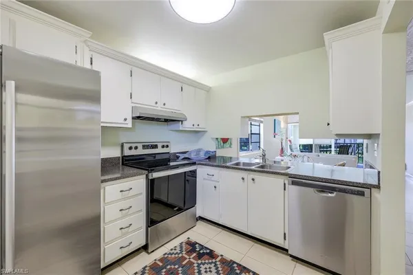 a kitchen with stainless steel appliances granite countertop a stove and a sink