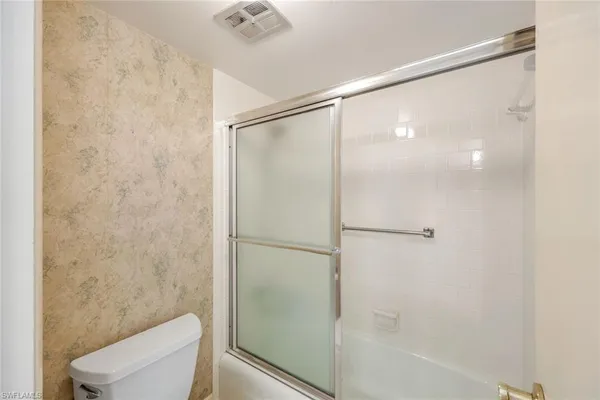 a spacious bathroom with a shower sink and mirror