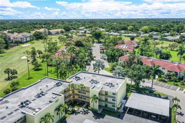 a aerial view of a house with a yard and lake view