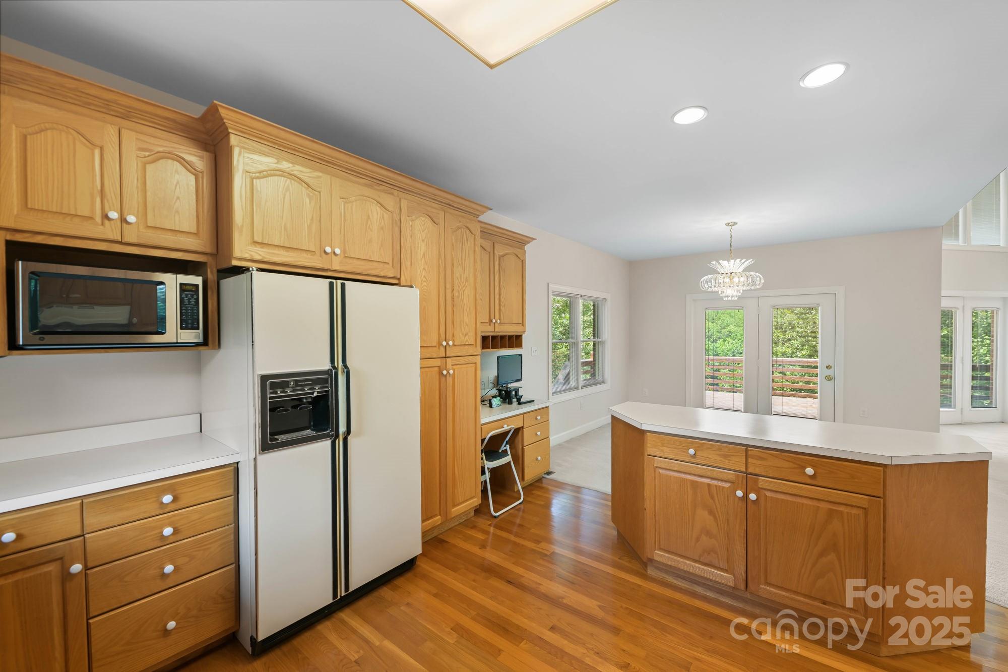 12041 Spinnaker Drive Tega Cay, SC 29708 - Photo 11 of 42 a kitchen with granite countertop cabinets stainless steel appliances and a window
