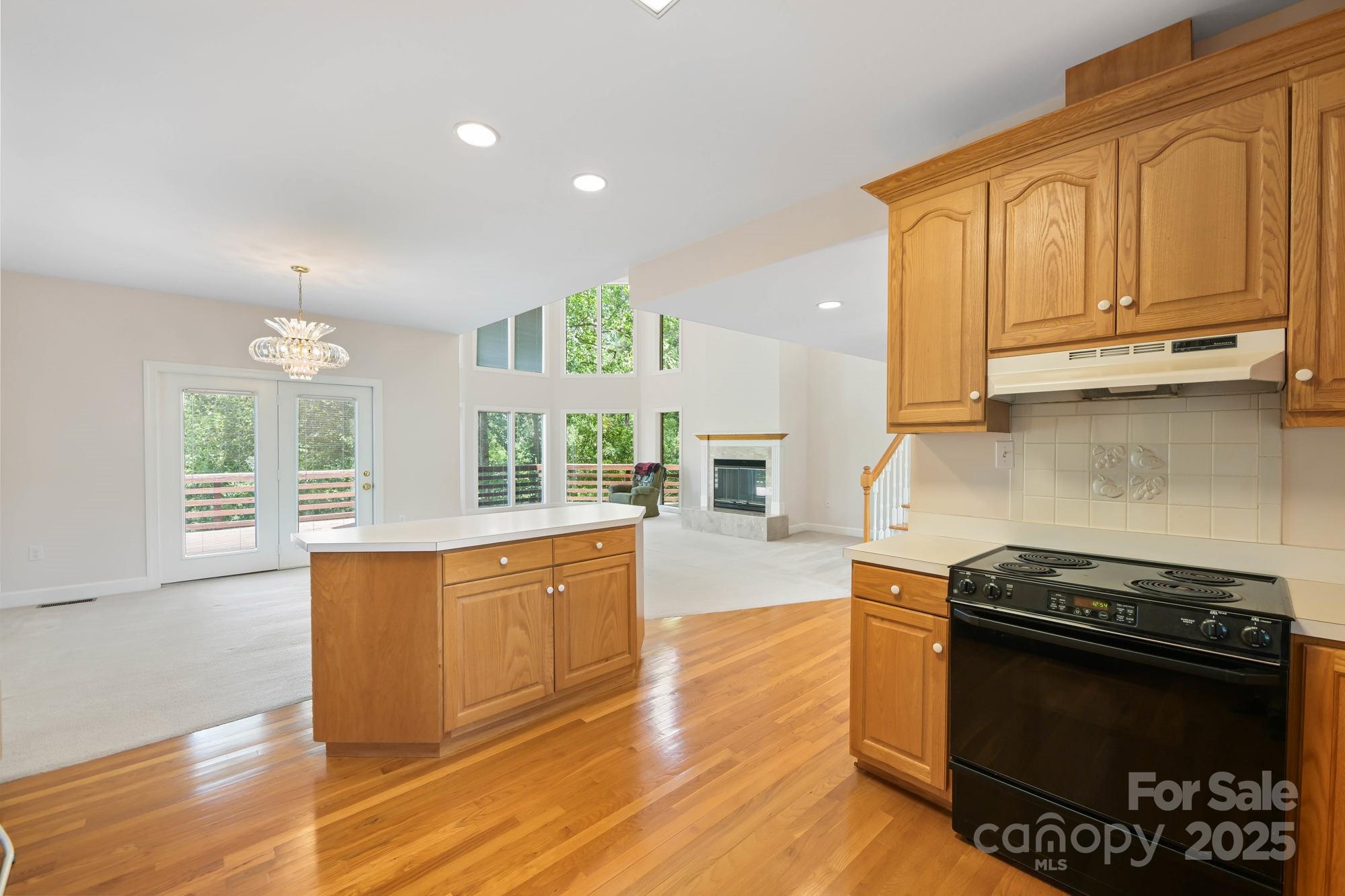 12041 Spinnaker Drive Tega Cay, SC 29708 - Photo 12 of 42 a kitchen with stainless steel appliances granite countertop a stove a sink and a microwave