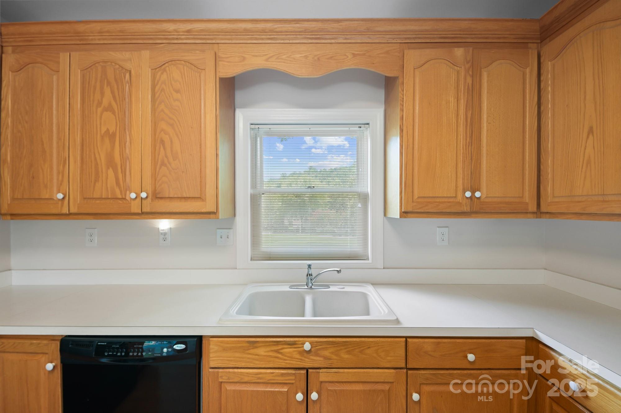 12041 Spinnaker Drive Tega Cay, SC 29708 - Photo 14 of 42 a kitchen with a sink and cabinets