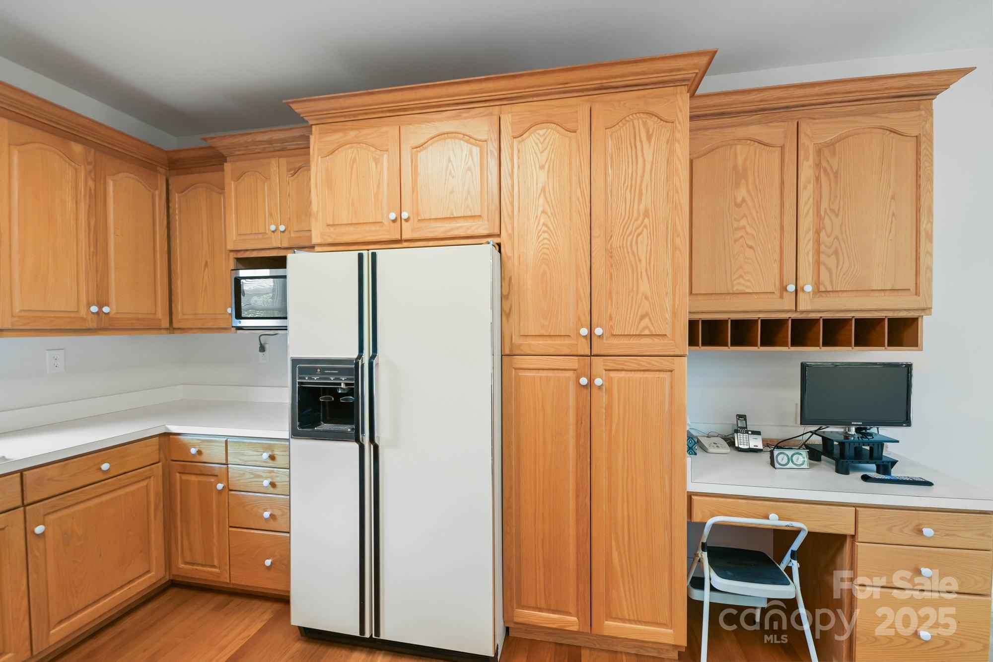 12041 Spinnaker Drive Tega Cay, SC 29708 - Photo 15 of 42 a kitchen with stainless steel appliances a refrigerator and cabinets