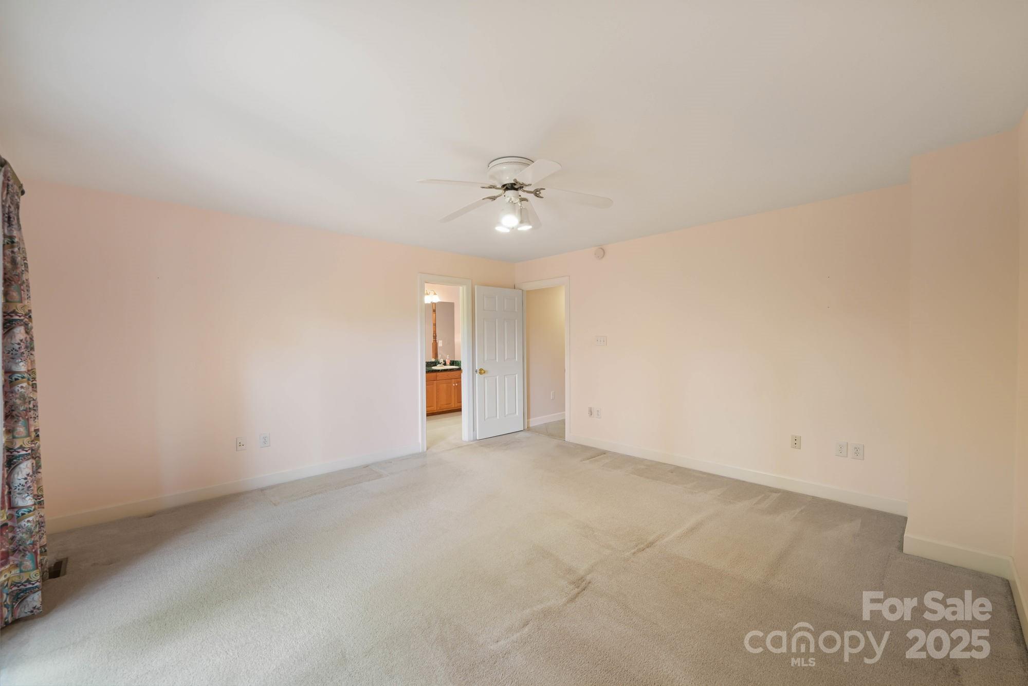 12041 Spinnaker Drive Tega Cay, SC 29708 - Photo 18 of 42 an empty room with a ceiling fan and a window
