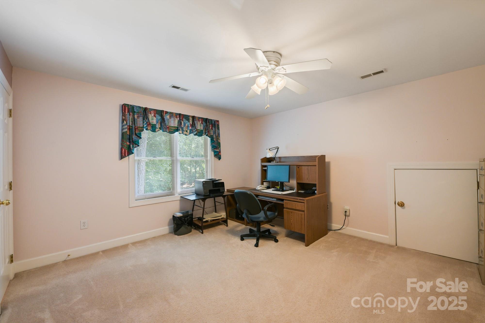 12041 Spinnaker Drive Tega Cay, SC 29708 - Photo 25 of 42 a view of a livingroom with workspace and a window