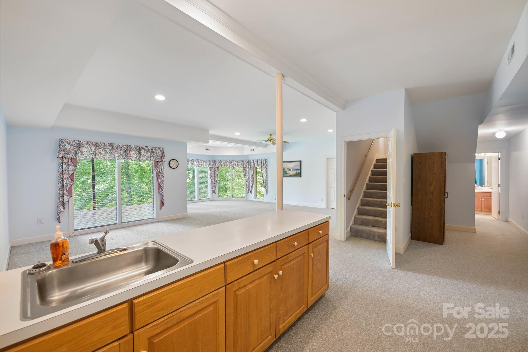12041 Spinnaker Drive Tega Cay, SC 29708 - Photo 32 of 42 a kitchen with stainless steel appliances granite countertop a sink and a refrigerator