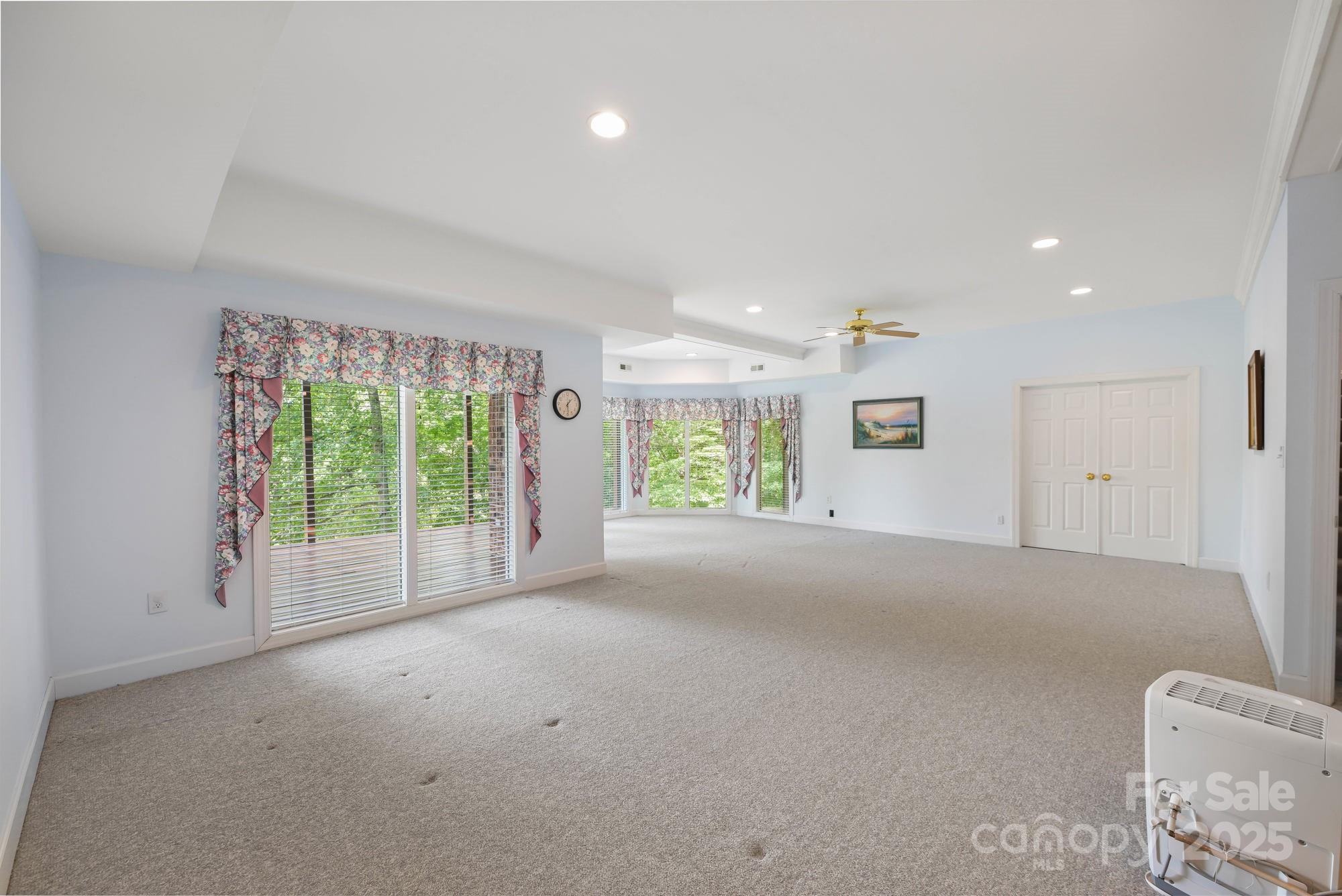 12041 Spinnaker Drive Tega Cay, SC 29708 - Photo 33 of 42 a view of a livingroom with furniture and floor to ceiling window