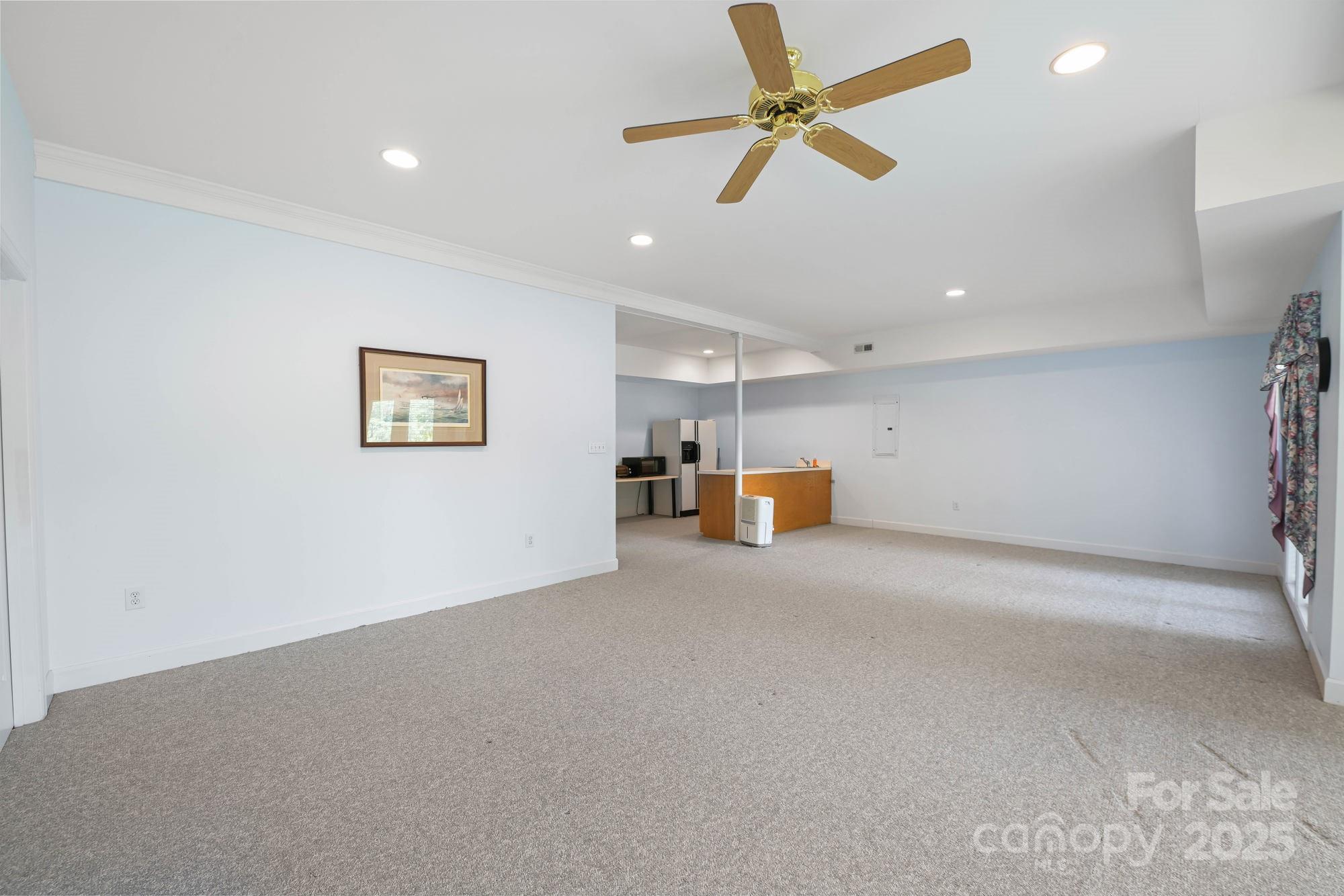12041 Spinnaker Drive Tega Cay, SC 29708 - Photo 38 of 42 a view of a livingroom with a ceiling fan
