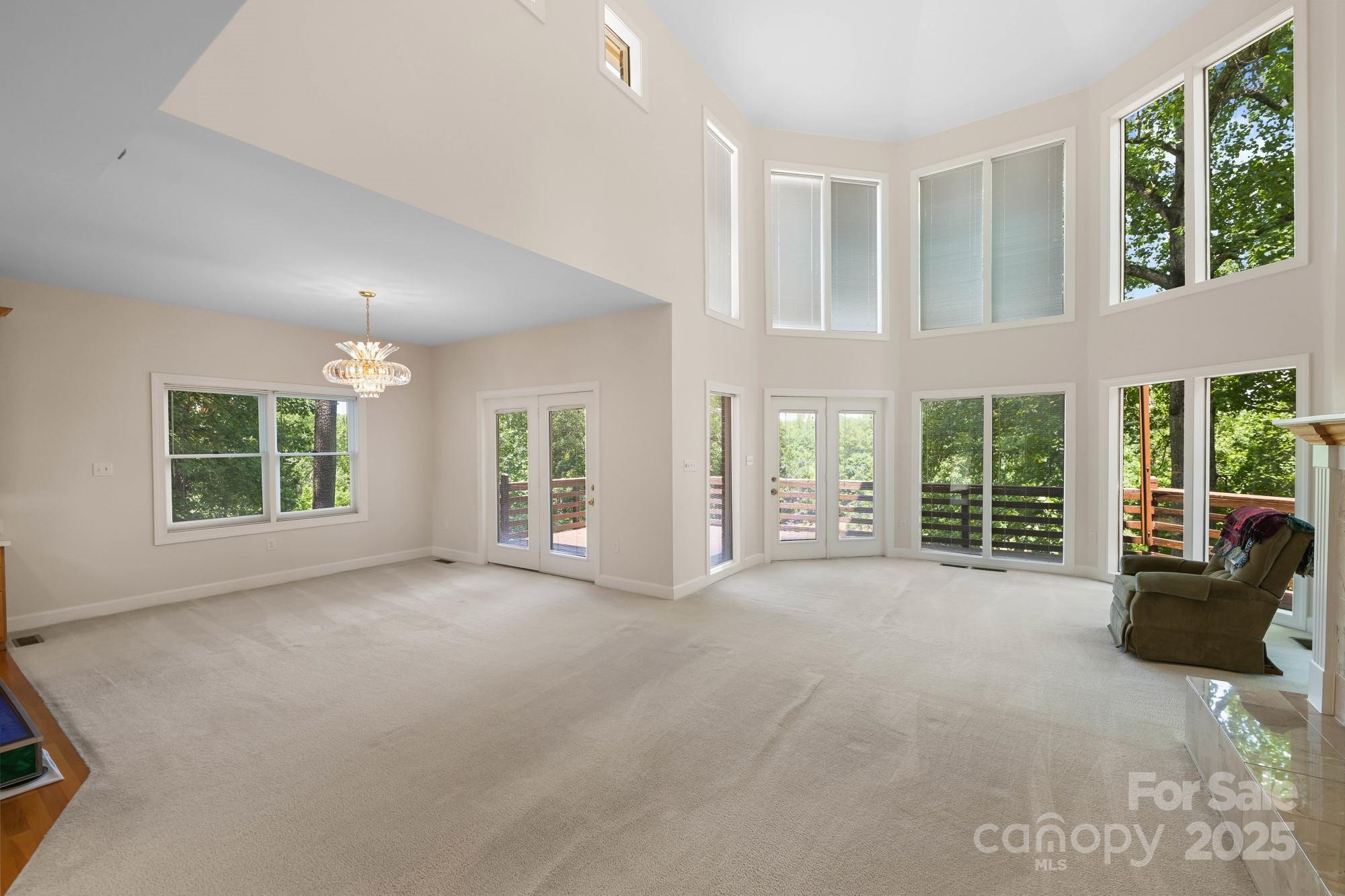 12041 Spinnaker Drive Tega Cay, SC 29708 - Photo 4 of 42 a view of an empty room with a balcony