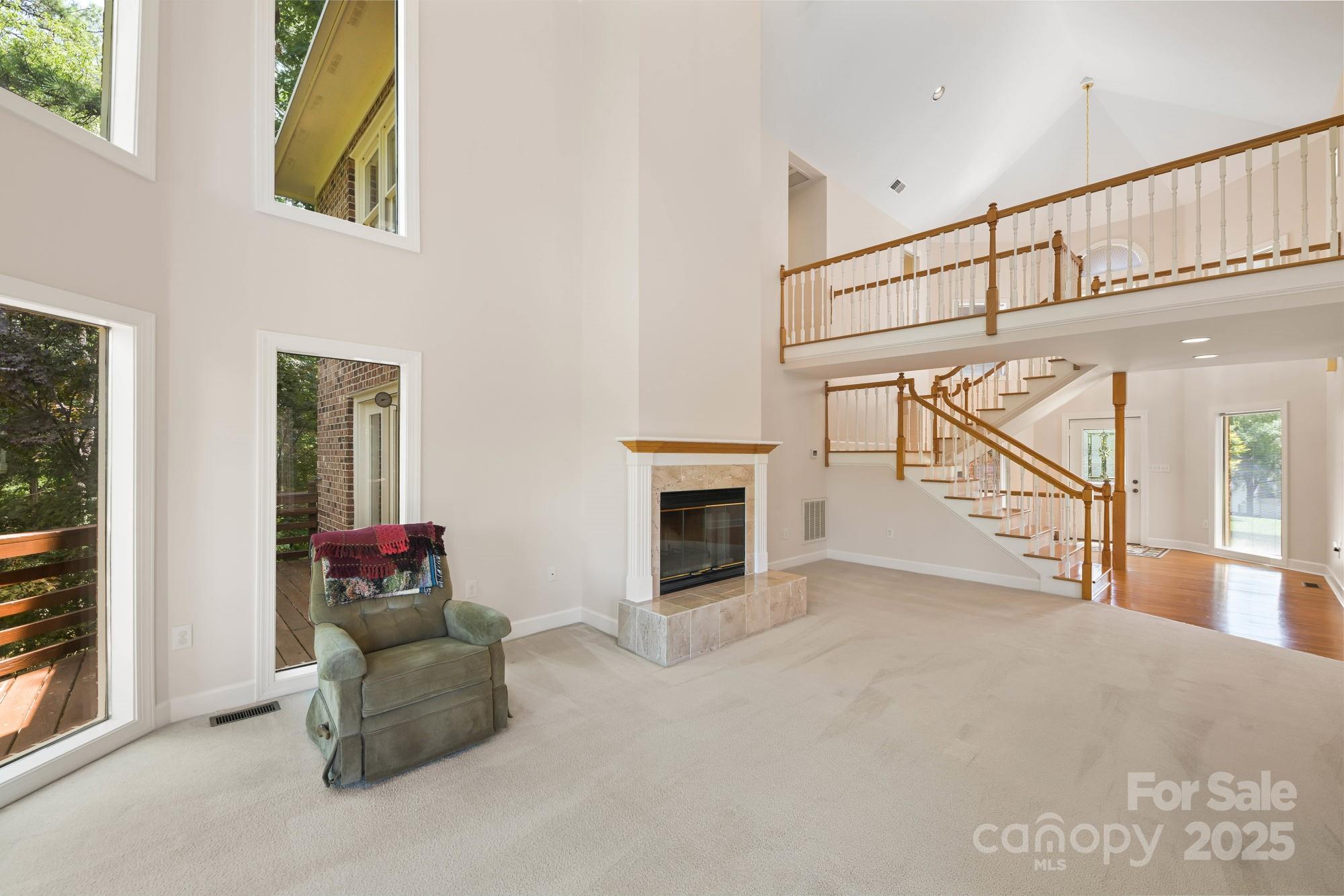 12041 Spinnaker Drive Tega Cay, SC 29708 - Photo 6 of 42 a view of livingroom with furniture staircase and windows