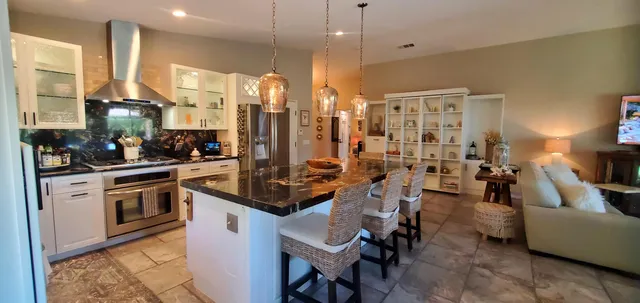 a kitchen with lots of counter top space a sink appliances and cabinets