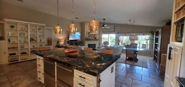 a kitchen with stainless steel appliances granite countertop a stove a sink and a refrigerator