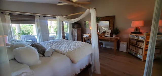 a bed sitting in a bedroom next to a window