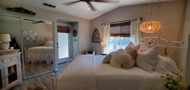 a bedroom with a bed and a chandelier