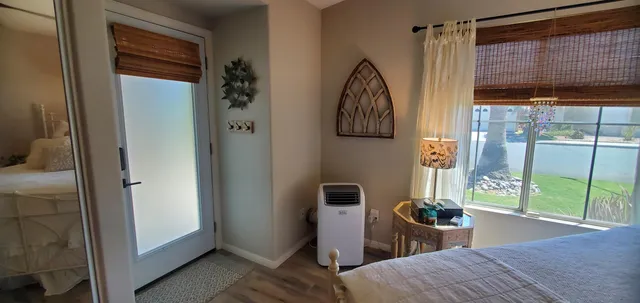 a bedroom with a bed and a window