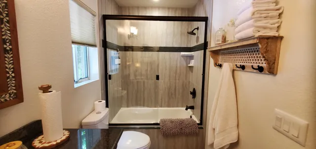 a bathroom with a sink toilet and shower