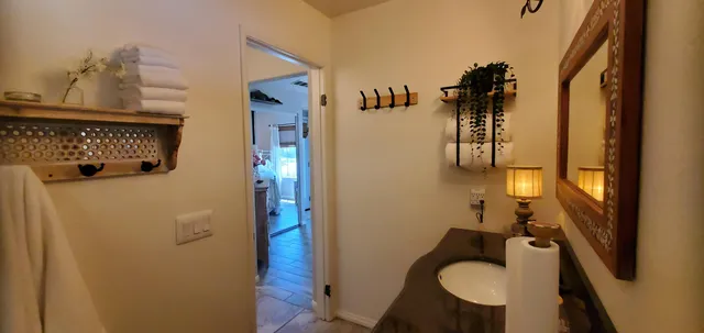a bathroom with a sink mirror vanity and toilet