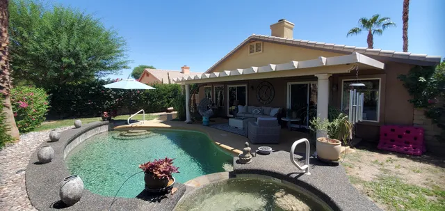 swimming pool view with a seating space
